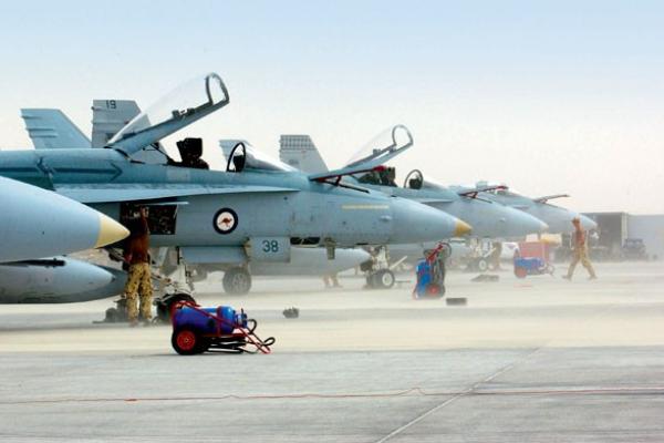Ground crews work on F/A-18s from No 75 Squadron amid a dust storm